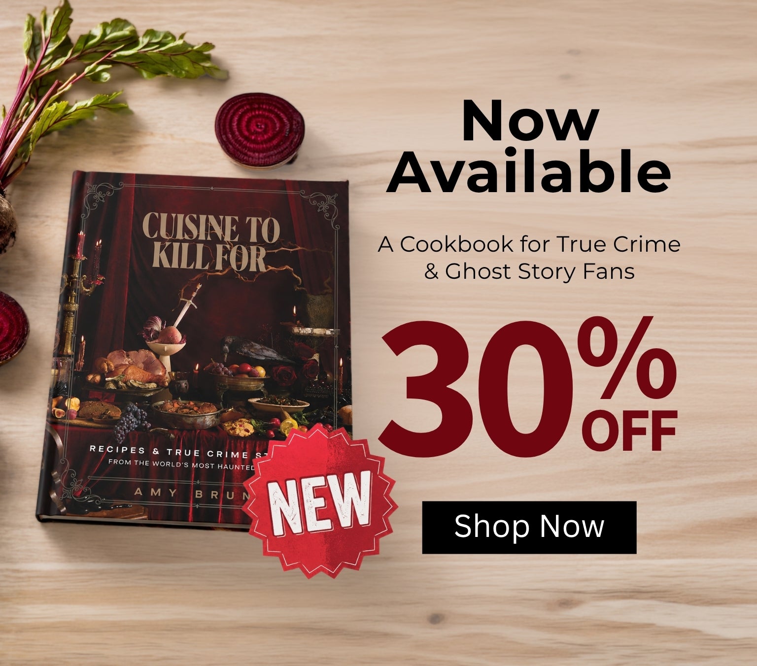Cookbook cover for 'Cuisine to Kill For' displayed on a light wood background with beet greens and sliced beets. The cover features a dark, moody illustration of a feast.