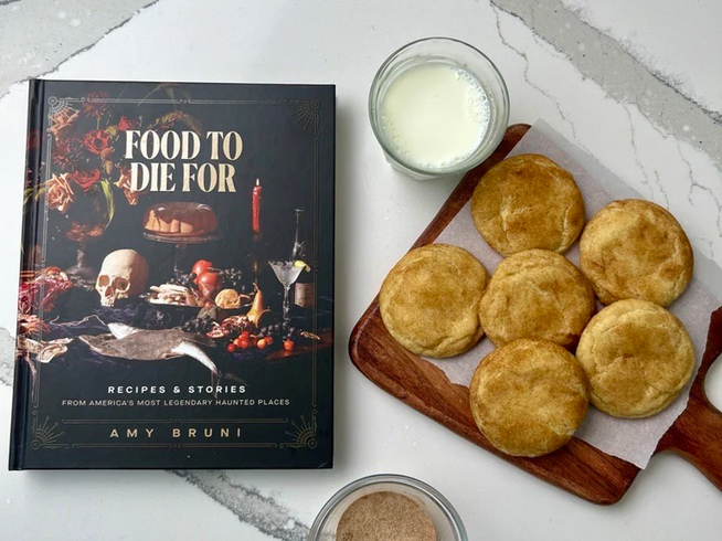 Cinnamon sugar cookies on a wooden board beside the Food to Die For cookbook