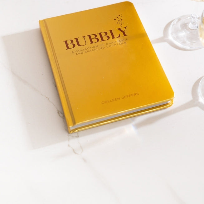 Yellow book titled 'Bubbly' on a white surface