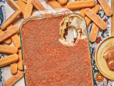 Dip in a glass dish surrounded by bread sticks on a decorative plate